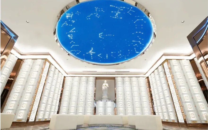 Symmetrical white and rose-gold hall beneath the circular blue celestial ceiling in The Sky columbarium at Nirvana 2